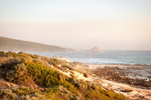 Ocean view of rugged coastline at sunset - Australian Stock Image