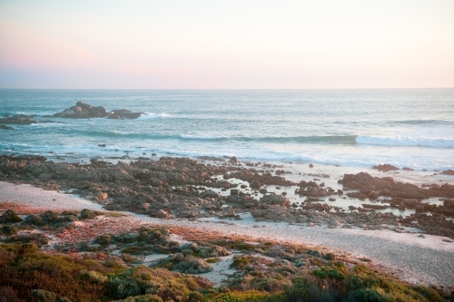 Ocean view of rugged coastline at sunset - Australian Stock Image