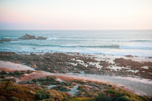 Ocean view of rugged coastline at sunset