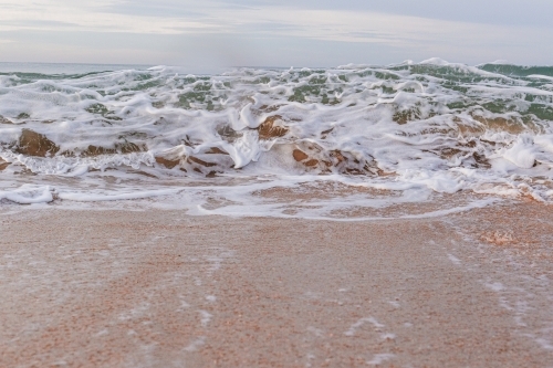 Ocean wave breaking onto shore