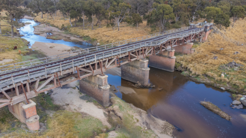 Old country railway bridge over a creek - Australian Stock Image