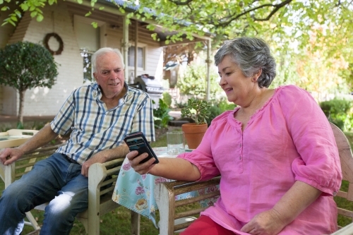Old couple spending time at their backyard. - Australian Stock Image