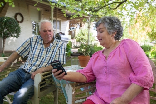 Old couple spending time at their backyard. - Australian Stock Image