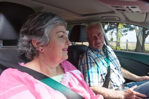 Old couple talking inside their car