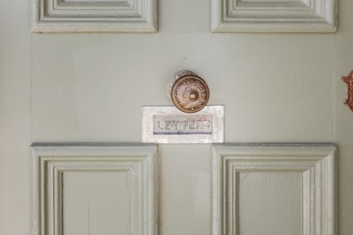Old door with doorknob and letter slot