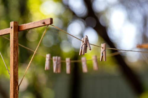 Old fashioned string clothes line with wooden pegs - Australian Stock Image