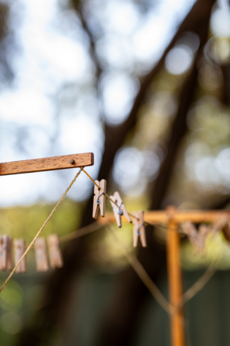Old fashioned string clothes line with wooden pegs - Australian Stock Image