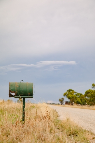 Old green mailbox on remote country road - Australian Stock Image