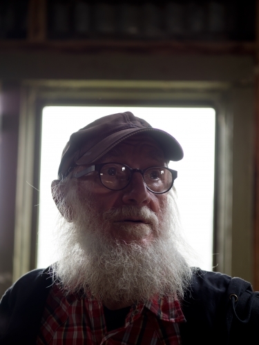 Old Man in Window Light - Australian Stock Image