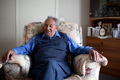 Old man resting in lounge chair - Australian Stock Image