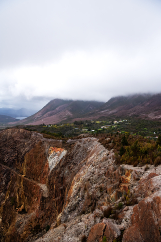 old open cut mine in valley on a cloudy day, Tasmania - Australian Stock Image