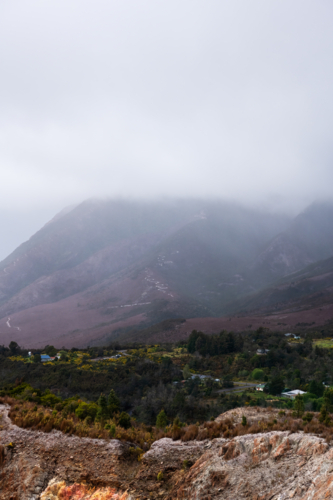 old open cut mine in valley on a cloudy day, Tasmania - Australian Stock Image