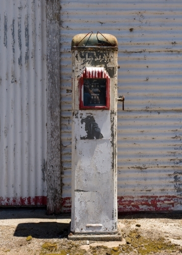 old petrol bowser in front of a corrugated iron shed - Australian Stock Image
