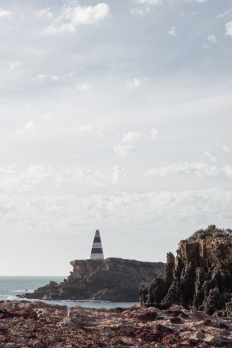 Old red an white striped obelisk (lighthouse) in Robe - Australian Stock Image