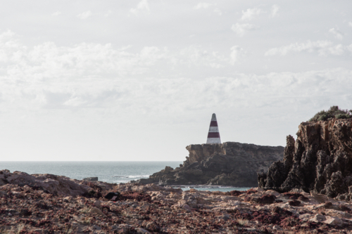 Old red and white striped Obelisk (lighthouse) in Robe - Australian Stock Image