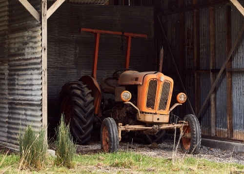 Old tractor in farm shed