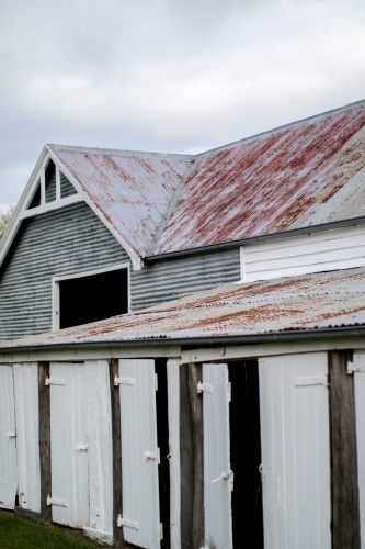 Old weathered work shed with timber doors and corrugated iron roofs
