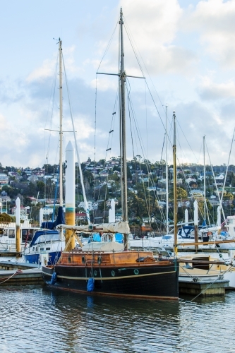 Old wooden boat moored in marina - Australian Stock Image
