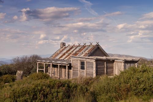 Old wooden hut at sunset - Australian Stock Image