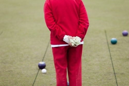Older woman watching lawn bowls - Australian Stock Image