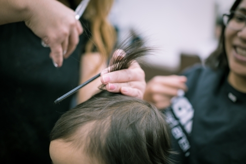One year old mixed race baby boy has his first haircut - Australian Stock Image
