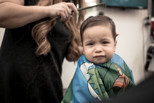 One year old mixed race baby boy has his first haircut - Australian Stock Image