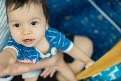 One year old mixed race boy rides with his mother on a Sydney city train