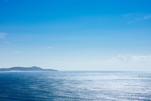 Open seas and a distant northern headland at Crescent Head - Australian Stock Image