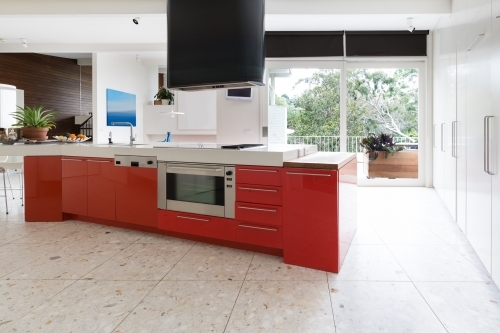 Orange kitchen cabinets in island bench in modern luxury home
