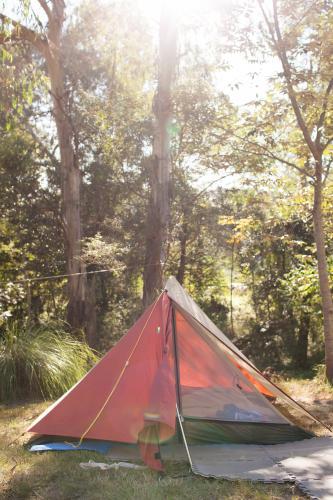 Orange tent at a campsite - Australian Stock Image