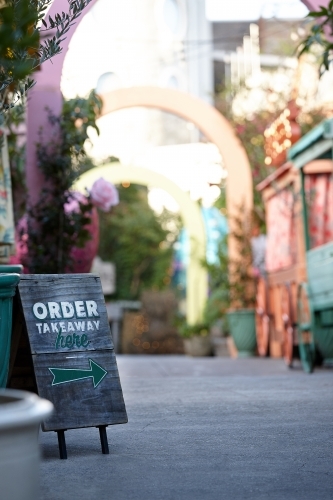 Order takeaway sign in restaurant alleyway - Australian Stock Image