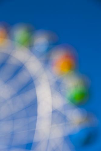 Out of focus image of a colourful ferris wheel