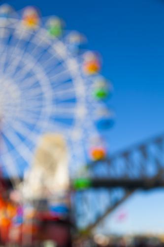 Out of focus image of a ferris wheel and sydney harbour bridge