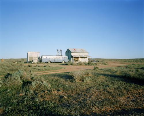 Outback cabin and bus with blue sky - Australian Stock Image