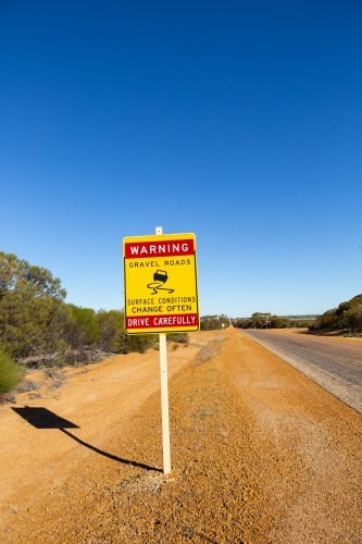 outback road sign warning of changing road conditions - Australian Stock Image