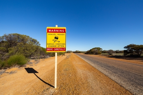 outback road sign warning of changing road conditions - Australian Stock Image