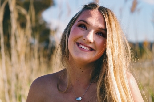 outdoor portrait of happy blonde young woman - Australian Stock Image
