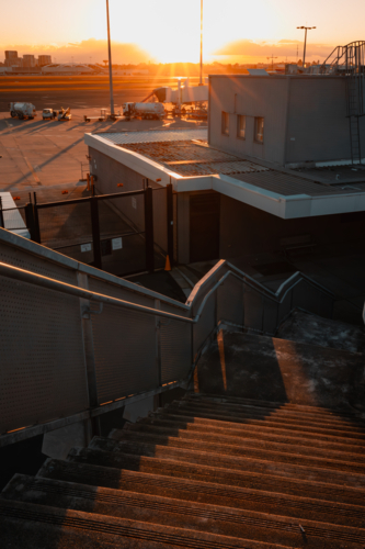 Outdoor staircase at Sydney Airport with runway in background - Australian Stock Image