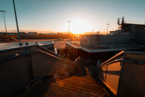 Outdoor staircase at Sydney Airport with runway in background - Australian Stock Image