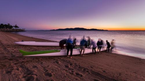 Outrigger canoe team preparing for a dawn training paddle.