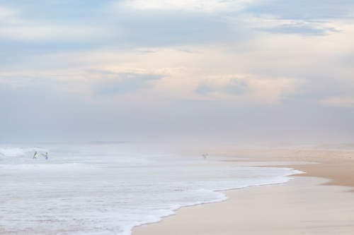 Overcast beach day with hazy sea spray filled sky - Australian Stock Image