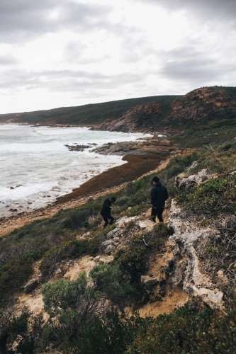 Overcast coastal landscape with two anonymous people - Australian Stock Image