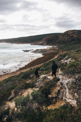 Overcast coastal landscape with two anonymous people