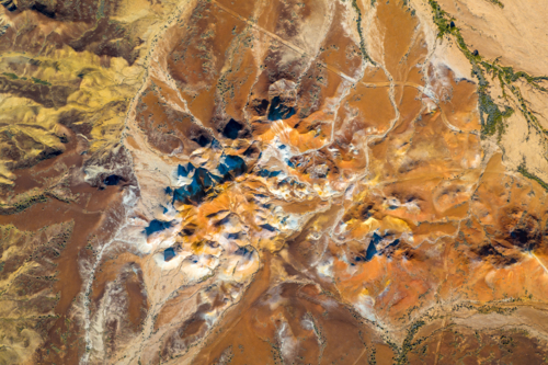 Overhead aerial view of a dramatic multicoloured outback mesa landscape with vivid ochre earth - Australian Stock Image