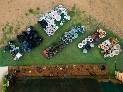overhead aerial view of stacked pots for sale at nursery - Australian Stock Image