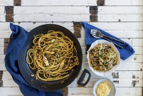 Overhead of roasted artichoke and noodles presented on table - Australian Stock Image