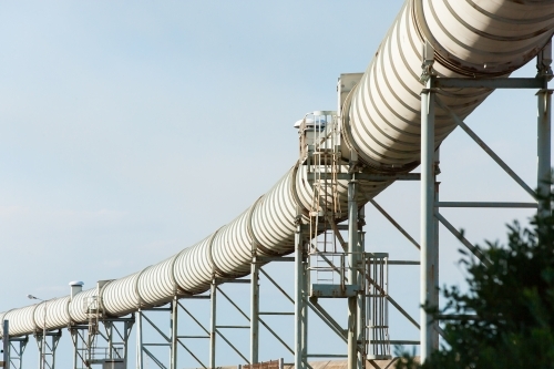 Overhead pipeline running to a port - Australian Stock Image