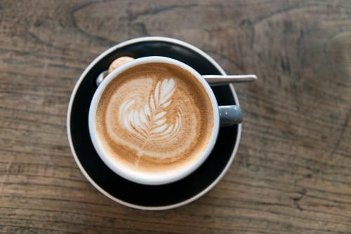 Overhead view of a coffee on a wooden table - Australian Stock Image