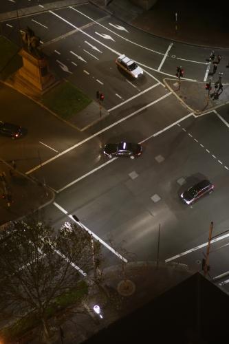 Overhead view of cars driving through an intersection in the city