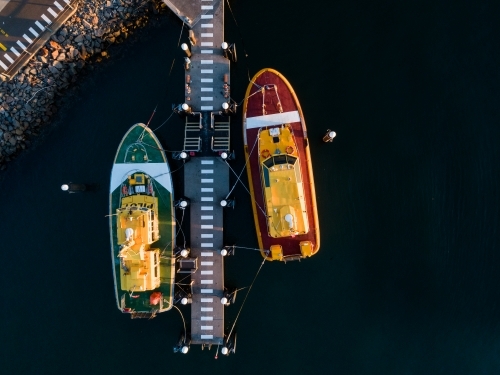 Overhead view of red and green port authority boats at Jetty on foreshore 